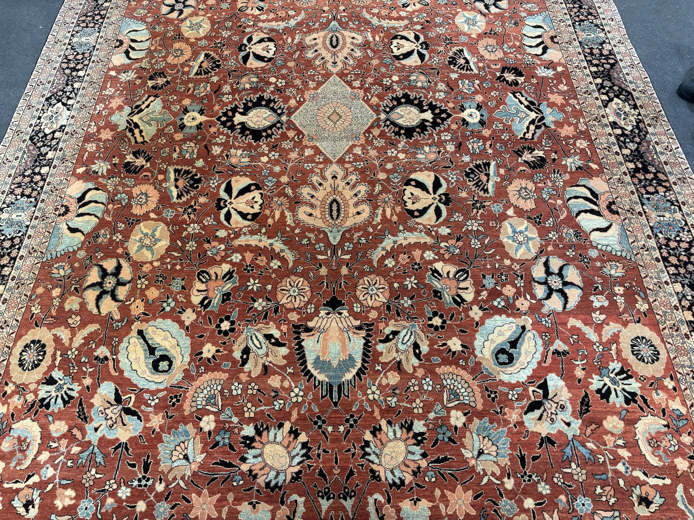 A Tabriz brick red ground gallery carpet 575 x 300cm